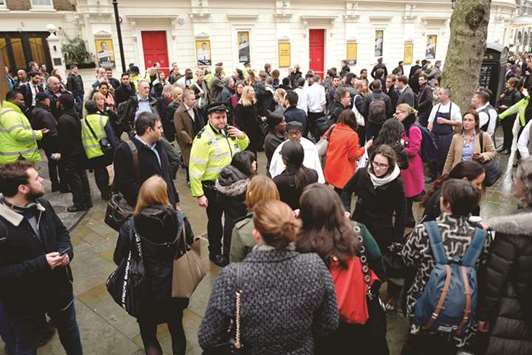 Workers are evacuated from offices on a street adjoining The Strand in central London yesterday after a gas leak closed The Strand and Charing Cross railway station.
