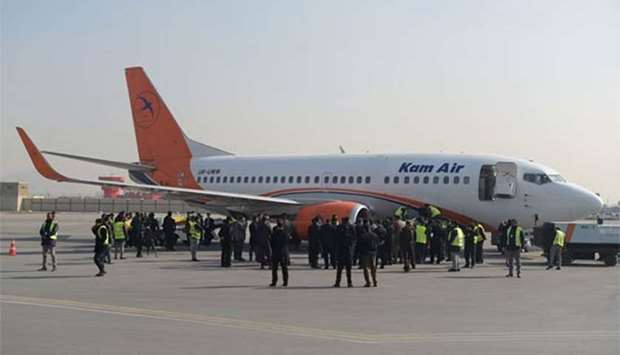 Kam Air employees gather by an airplane, at a ceremony for Ukrainian employees of the Afghan airline, at Kabul International Airport on Wednesday.