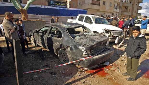 Libyans check the aftermath of an explosion in the eastern city of Benghazi on Wednesday.