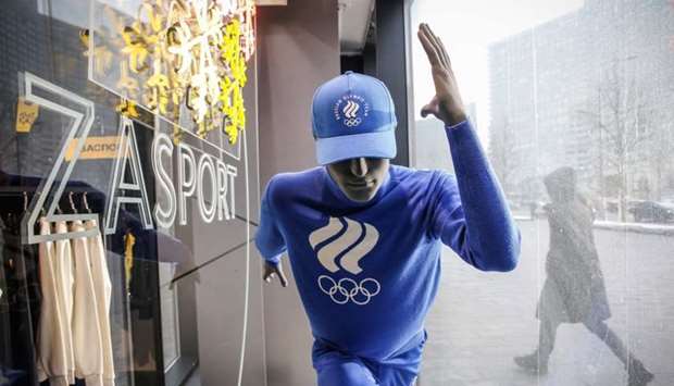 A man walks past a Russian sportswear outlet shop called Zasport, the company who designed the IOC-approved uniforms for the Russian Olympic Athletes, in Moscow.