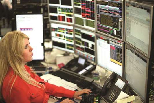 A trader is seen at the London Stock Exchange. The FTSE 100 lost 1.1% to 7,643.43 points yesterday.