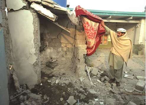 A tribesman inspects the site of a drone strike in Mamuzai in the Kurram tribal district yesterday.