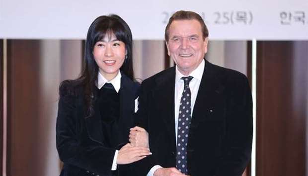 Former chancellor of Germany Gerhard Schroeder poses with his South Korean partner Kim So-Yeon as they attend a press conference in Seoul on Thursday. 