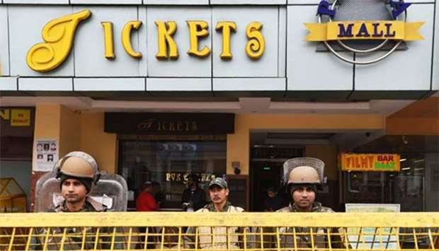 Indian riot police personnel stand guard at the entrance of a cinema hall scheduled to screen Bollywood film Padmaavat in New Delhi on Thursday.