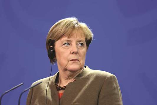 Germanyu2019s chancellor Angela Merkel pauses during a news conference in Berlin. The surprisingly bullish business figures, released by the Ifo economic institute, bode well for future growth and give Merkel a tailwind as she tries to form a coalition government with the centre-left Social Democrats.