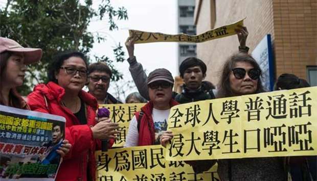 A group of Pro-China demonstrators shout slogans against Hong Kong Baptist University students demonstrating against a mandatory Mandarin language requirement, in Hong Kong on Friday.