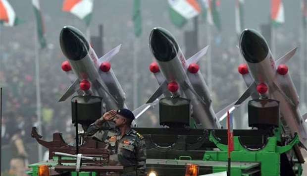 An Indian Army personnel salutes from a Akash Rocket Launcher vehicle during India\'s 69th Republic Day Parade in New Delhi on Friday.
