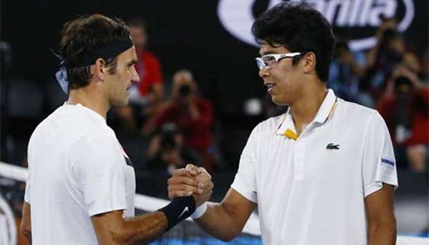 South Korea's Chung Hyeon shakes hands with Switzerland's Roger Federer after Chung retired from the Australian Open semi-final due to injury.