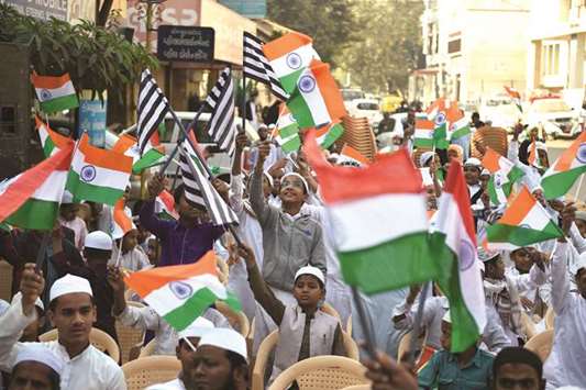 People wave Indian flags while participating in a flag hoisting event as they celebrate Indiau2019s 69th Republic Day in Ahmedabad yesterday.
