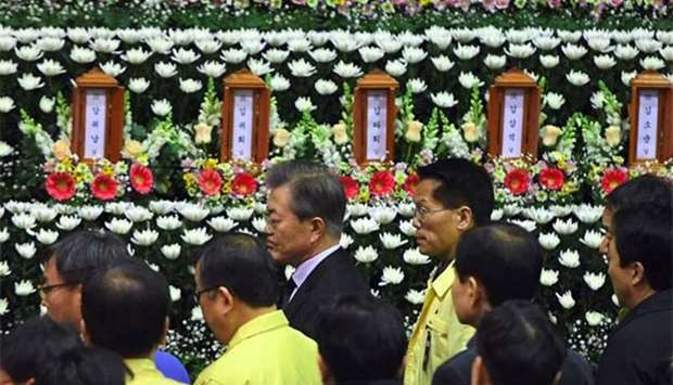 South Korean President Moon Jae-In (centre) visits a joint memorial altar for the victims of a hospital fire at a gymnasium in Miryang on Saturday.