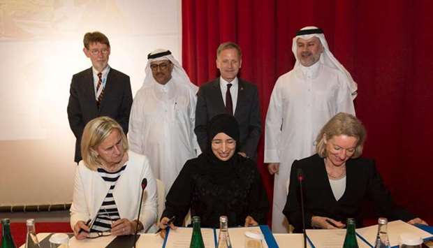 HE Dr Hanan Mohamed al-Kuwari, Minister of Public Health, Prof Dr Annette Gru00fcters-Kieslich and Irmtraut Gu00fcrkan sign the agreement.