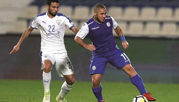 Al Khoru2019s Madson (right) and Al Kharaitiyatu2019s Mahmoud Saad vie for the ball during the QNB Stars League match yesterday.