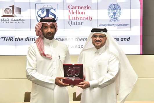 Lieutenant AbdulAziz al-Ahmed and Jamal al-Baker exchange a memento.