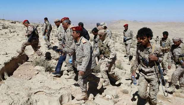 Yemeni soldiers walk on a mountain on the frontline of fighting with Houthis in Nihem area near Sanaa, yesterday.