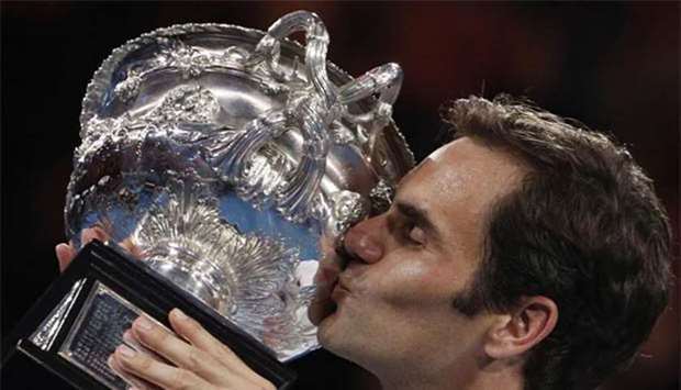 Roger Federer kisses the trophy after winning the Australian Open in Melbourne on Sunday.