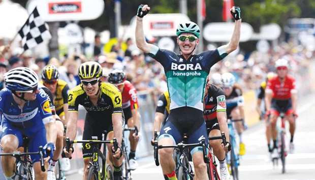 Australian rider Jay McCarthy of Bora-Hansgrohe (R) celebrates as he wins the Cadel Evans Great Ocean Road cycling race in Geelong yesterday.
