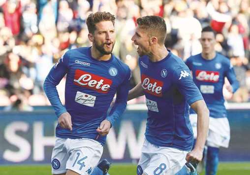 Napoliu2019s Dries Mertens (left) celebrates with Jorginho after scoring a goal against Bologna yesterday. (Reuters)