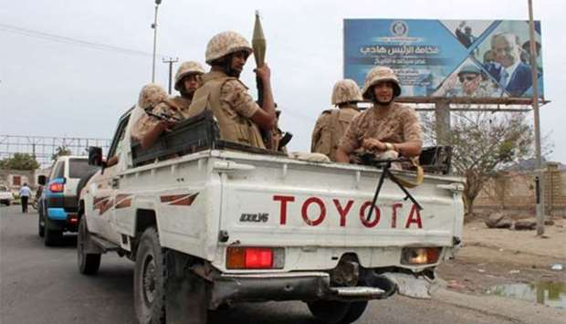 Fighters from Yemen's southern separatist movement sit in the back of a pick-up truck in Aden.