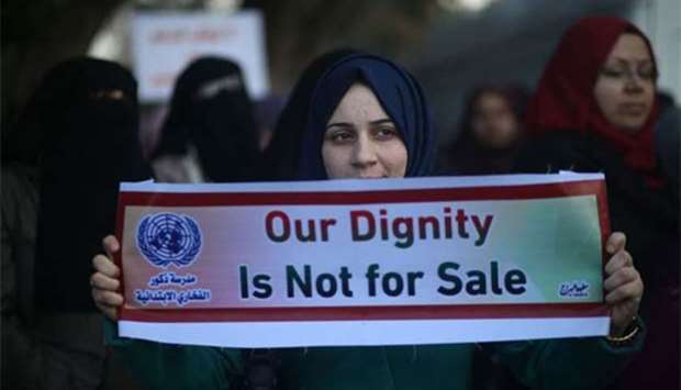 Palestinian women take part in a protest in Gaza City on Monday against the US move to freeze funding for the UN agency for Palestinian refugees.