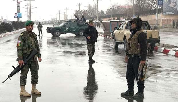 Afghan security forces stand near the Marshal Fahim military academy after a series of explosions in Kabul, Afghanistan.