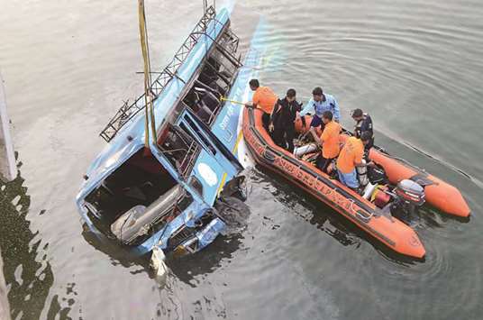 Rescue efforts are launched after the bus accident at the Ghogra canal in Murshidabad district yesterday.