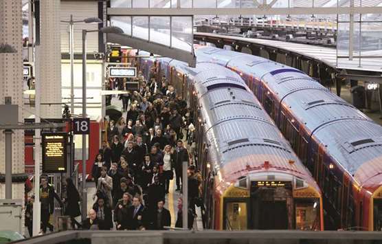 On the day that rail fares increased, passengers arrive at Waterloo Station in London.
