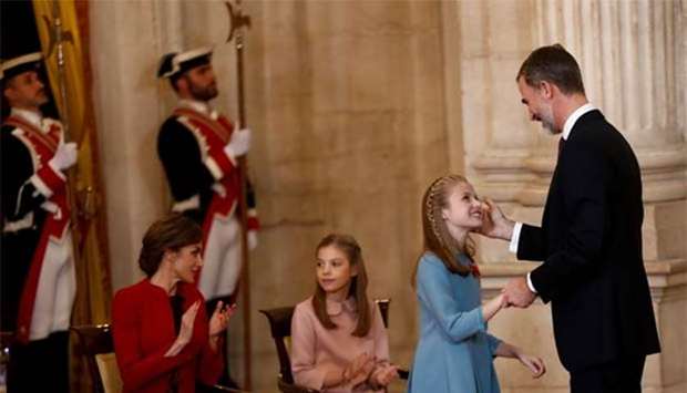 Spain's King Felipe caresses his daughter Princess Leonor after presenting her with the insignia of the ,Toison de Oro, (Order of the Golden Fleece) during a ceremony at the Royal Palace in Madrid on Tuesday.