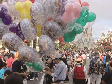 CROWDED: A Disney World employee sells balloons at the crowded Magic Kingdom park after Christmas.