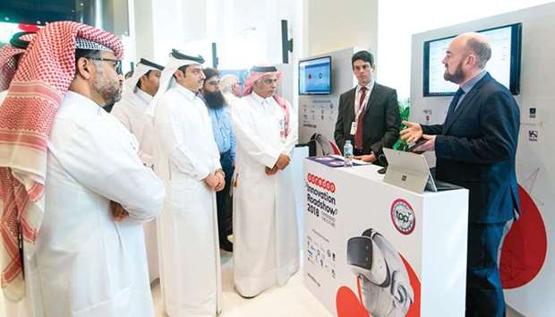 Ooredoo COO Yousuf Abdulla al-Kubaisi and other officials listening to a demonstration during the roadshow.