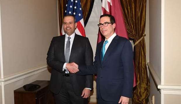 HE the Minister of Economy and Commerce Sheikh Ahmed bin Jassim bin Mohamed al-Thani shakes hands with US Treasury Secretary Steven Mnuchin in Washington, DC.