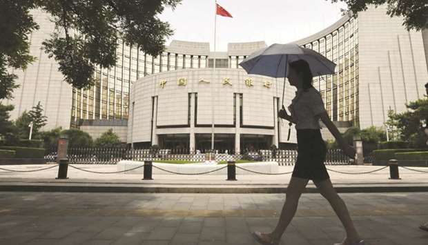 The Peopleu2019s Bank of China building in Beijing. The PBoC is more likely to raise open-market interest rates in the first half because there will probably be more headwinds for the economy in the latter six months, according to a Beijing-based analyst.