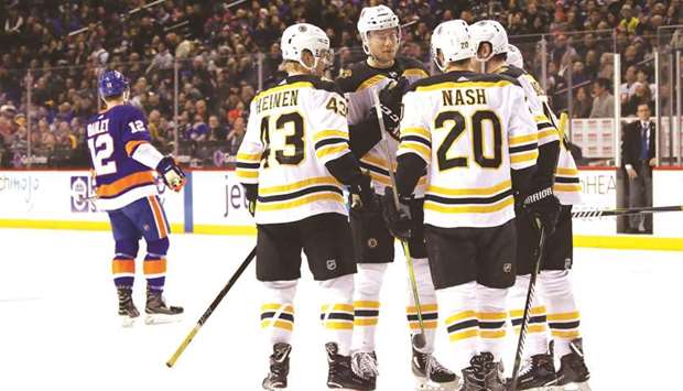 The Boston Bruins players celebrate a goal by Danton Heinen (left) in the first period of their NHL game against the New York Islanders at the Barclays Centre. (Getty Images/AFP)