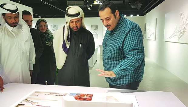 Mohamed Mohanad Barakat (right) briefs Dr Khalid Bin Ibrahim al-Sulaiti on his works during the opening of the exhibition at Katara on Tuesday. PICTURE: Joey Aguilar