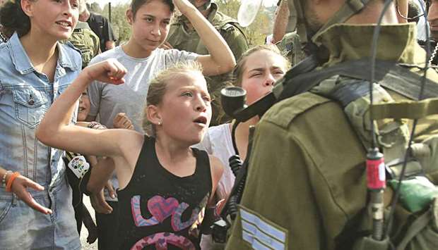 Ahed Tamimi confronting an Israeli soldier during a protest in 2012.