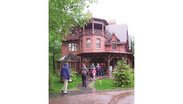 FOOTPRINTS: The Mark Twain House set in a leafy neighbourhood of Hartford, Connecticut, was home to famed American author, his wife and three daughters from 1874-1891; right, the famous author relaxing at home.