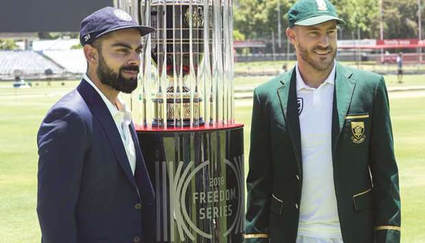 Indiau2019s captain Virat Kohli (left) and South Africau2019s skipper Faf du Plessis pose with trophy yesterday, ahead of the first Test in Cape Town . (AFP)