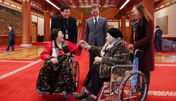 South Korean President Moon greets South Korean women who were forced to work in Japanese wartime brothels as ,comfort women,, in Seoul