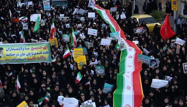 Iranian pro-government supporters march in the city of Najafabad