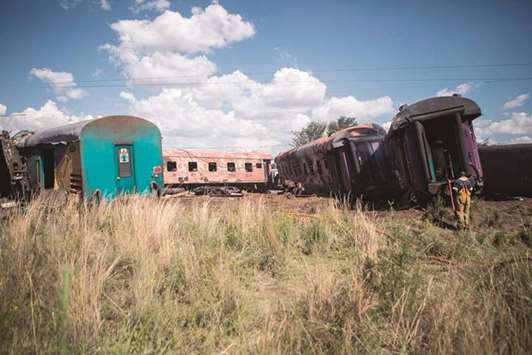 An emergency service worker seen at the site where a train crashed into a truck in Kroonstad, Free State Province, South Africa, yesterday.