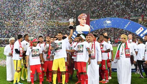 Oman's goalkeeper Fayez Issa al-Rusheidi holds the trophy next to his teammates after his team won the Gulf Cup of Nations 2017 final football match between Oman and the UAE at the Sheikh Jaber al-Ahmad Stadium in Kuwait City