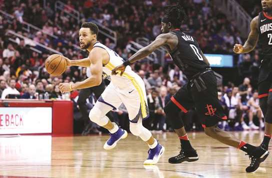 Golden State Warriors guard Stephen Curry (left) in action against the Houston Rockets during their NBA game at Toyota Center in Houston, Texas, on Thursday. (USA TODAY Sports)