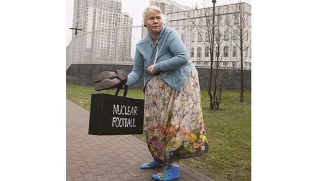 An activist of womenu2019s rights group Femen, with make-up applied to look like US President Donald Trump, is seen at a protest near the US embassy in Kyiv yesterday, The protest was against the war of words between Trump and North Korean leader Kim Jong-un.