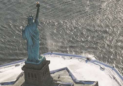 A snowplough is seen working on Liberty Island, next to the Statue of Liberty, in New York City.
