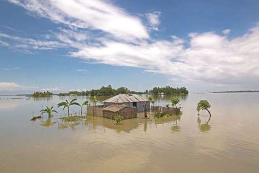 A house sinks into the water in Lalmonirhat, Bangladesh, where flooding triggered by torrential rains has displaced hundreds of thousands of people.