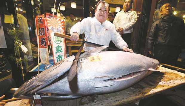 President of sushi restaurant chain Sushi-Zanmai, Kiyoshi Kimura, displays a 190kg bluefin tuna at his main restaurant near Tokyou2019s Tsukiji fish market yesterday.