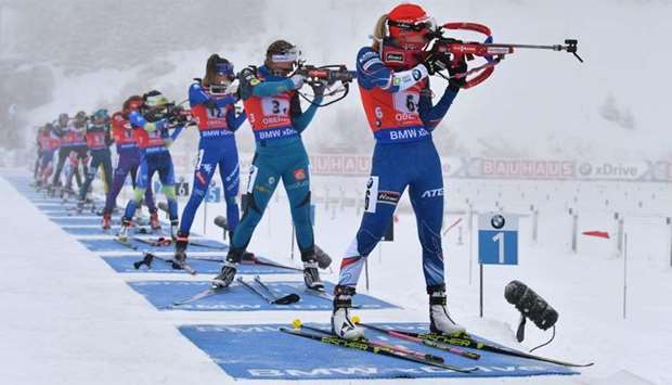 Athletes compete at the shooting range during the women's 4 x 6 km relay event of the IBU Biathlon World Cup in Oberhof