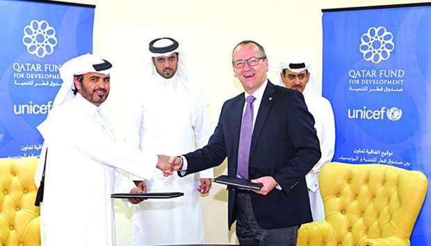 Qatar Fund for Development and Unicef officials led agreement signing recently.