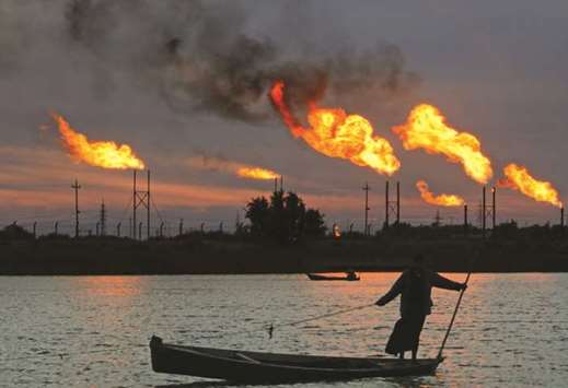 Flames emerge from flare stacks at the oil fields in Basra (file). Opecu2019s second-biggest member, Iraq, made less than half its pledged cuts and has eaten away at its neighbouru2019s share of these critical markets.