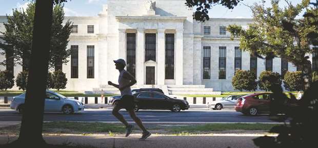 A runner passes the Federal Reserve building in Washington, DC (file). During the December 12-13 meeting of the rate-setting Federal Open Market Committee, at which Fed officials lifted the policy rate by a quarter point to a range of 1.25% to 1.5%, u201csomeu201d were concerned that an inverted yield curve hadnu2019t lost its predictive power as a recession warning, according to the minutes.