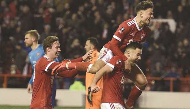 Nottingham Forestu2019s Ben Brereton (right) celebrates with teammates after scoring against Arsenal during the English FA Cup third round match at The City Ground in Nottingham, central England, yesterday. (AFP)